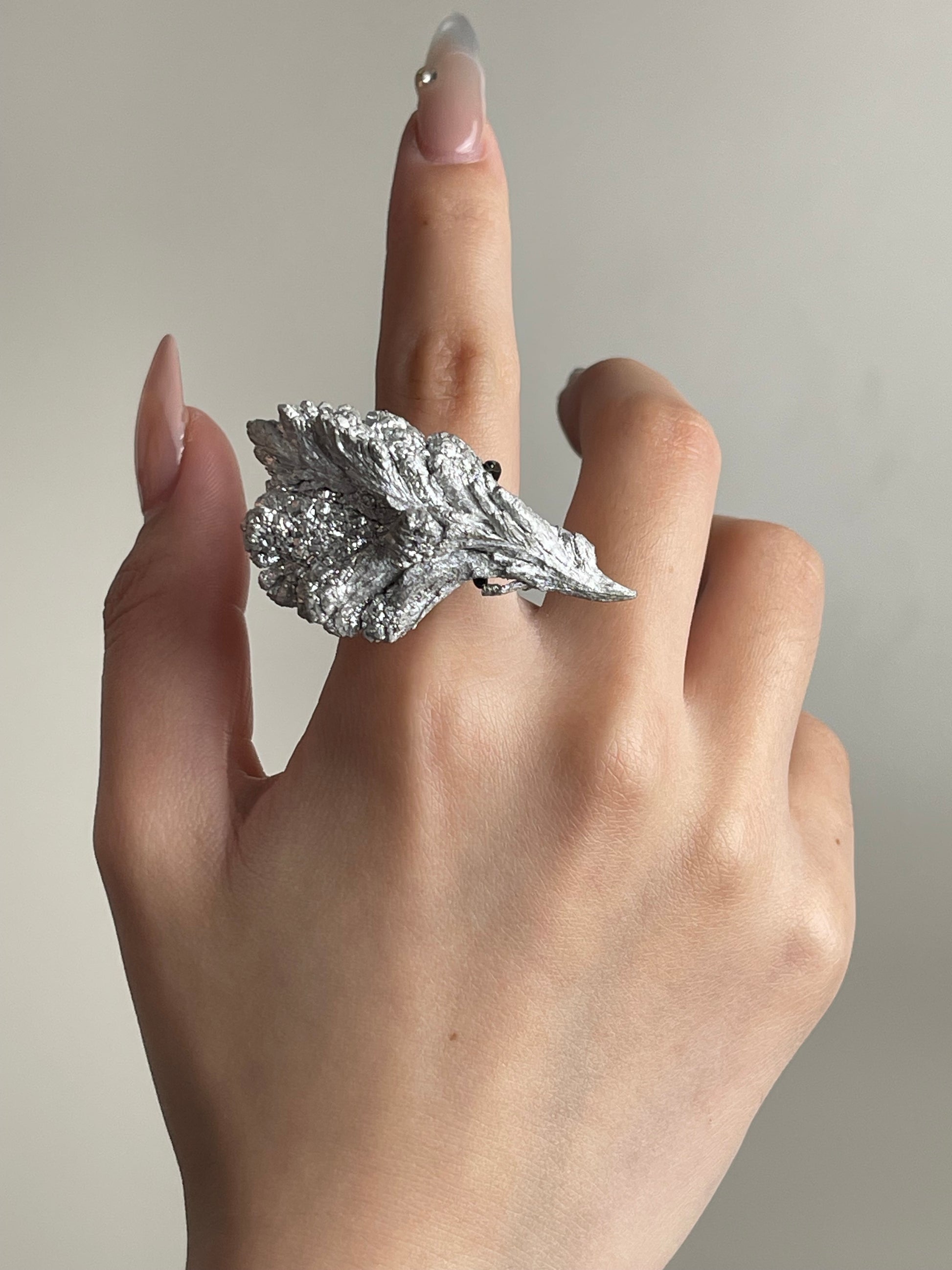 magnesium crystal mineral specimen ring worn on hand