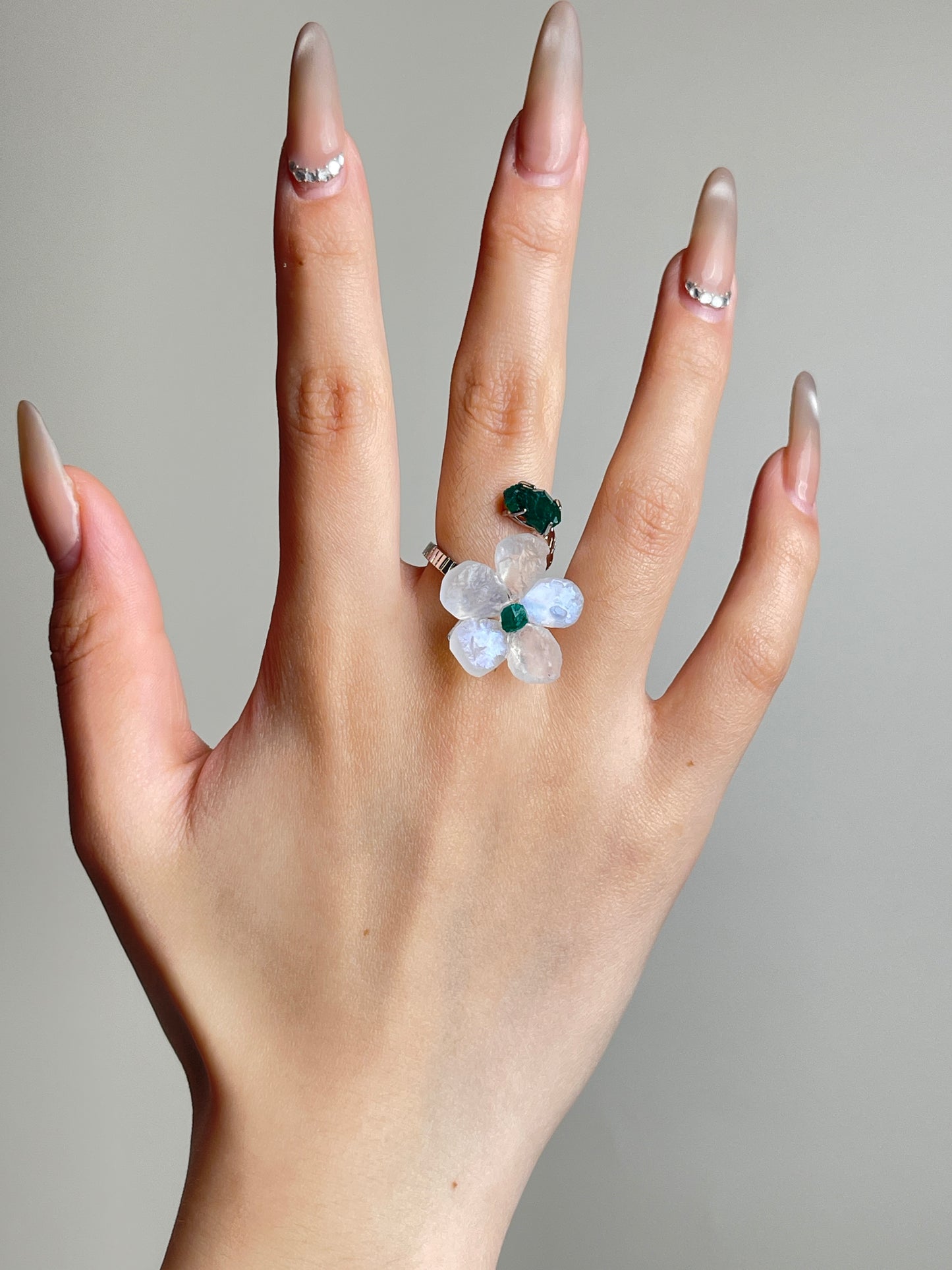 Moonstone and Dioptase crystal flower ring worn on hand