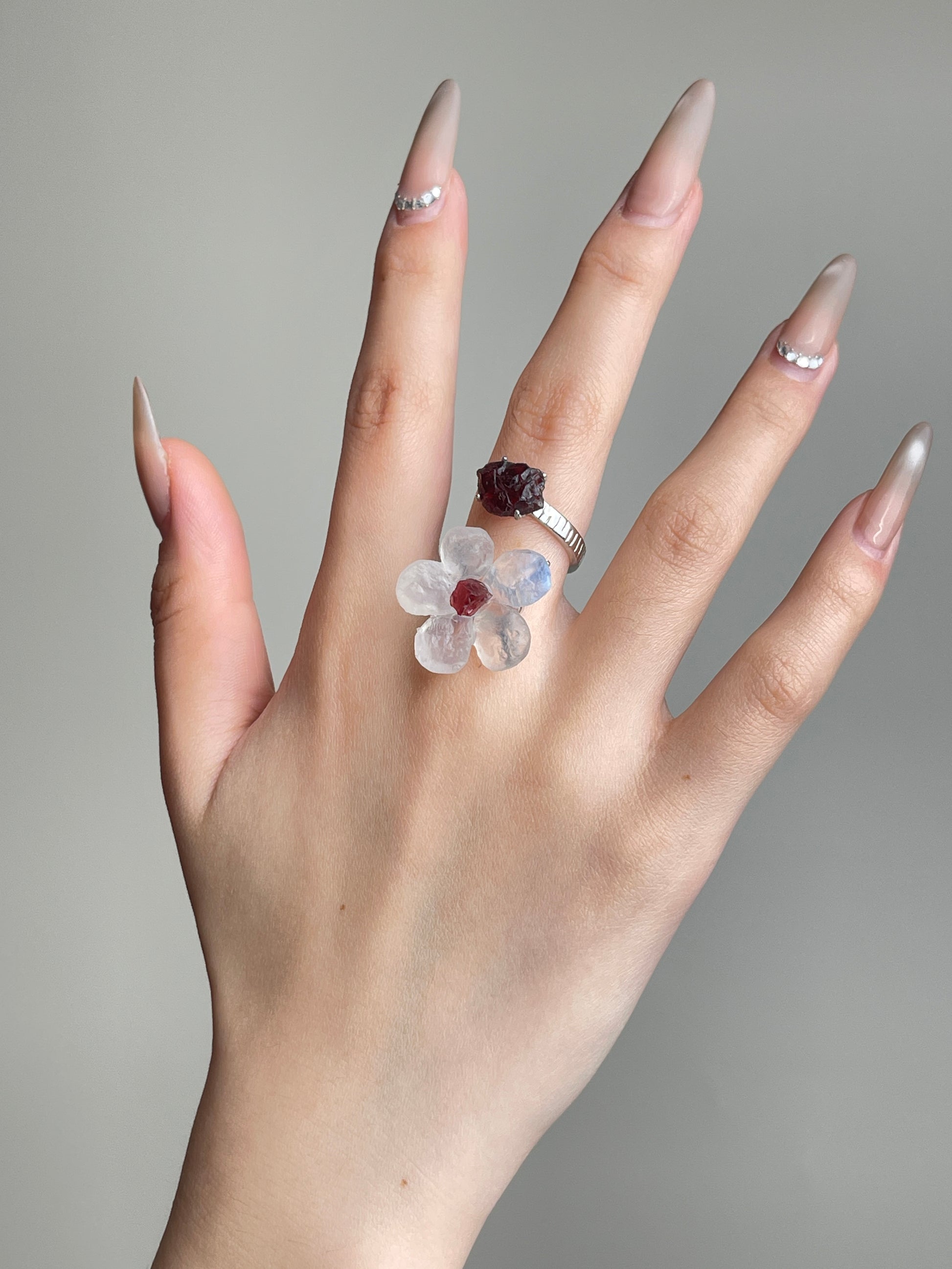 Moonstone and Garnet crystal flower ring worn on hand