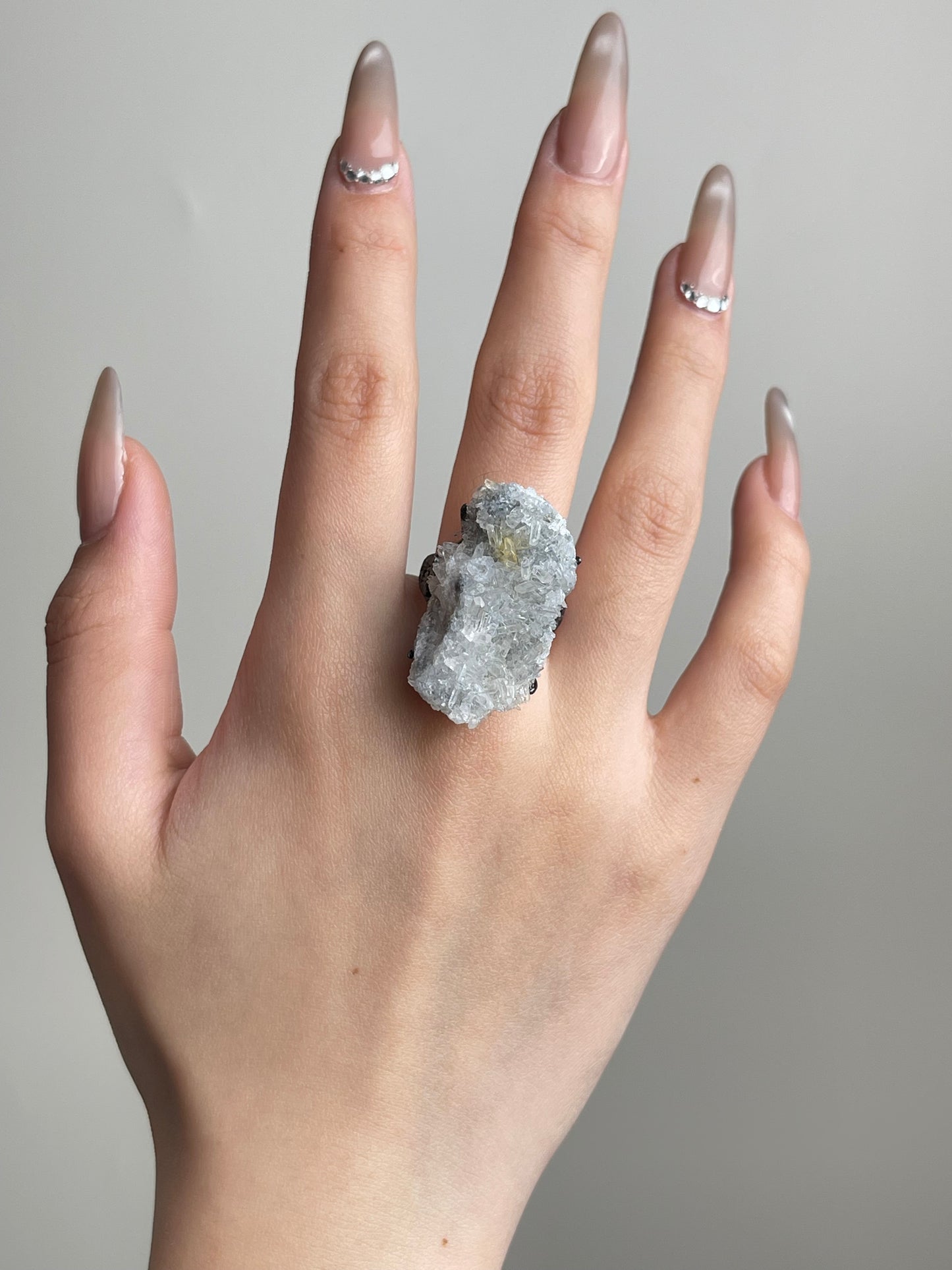 Needle Quartz Cluster Ring held in hand