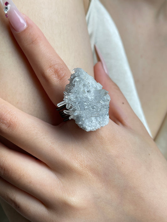 Close-up hand wearing Needle Quartz crystal cluster ring