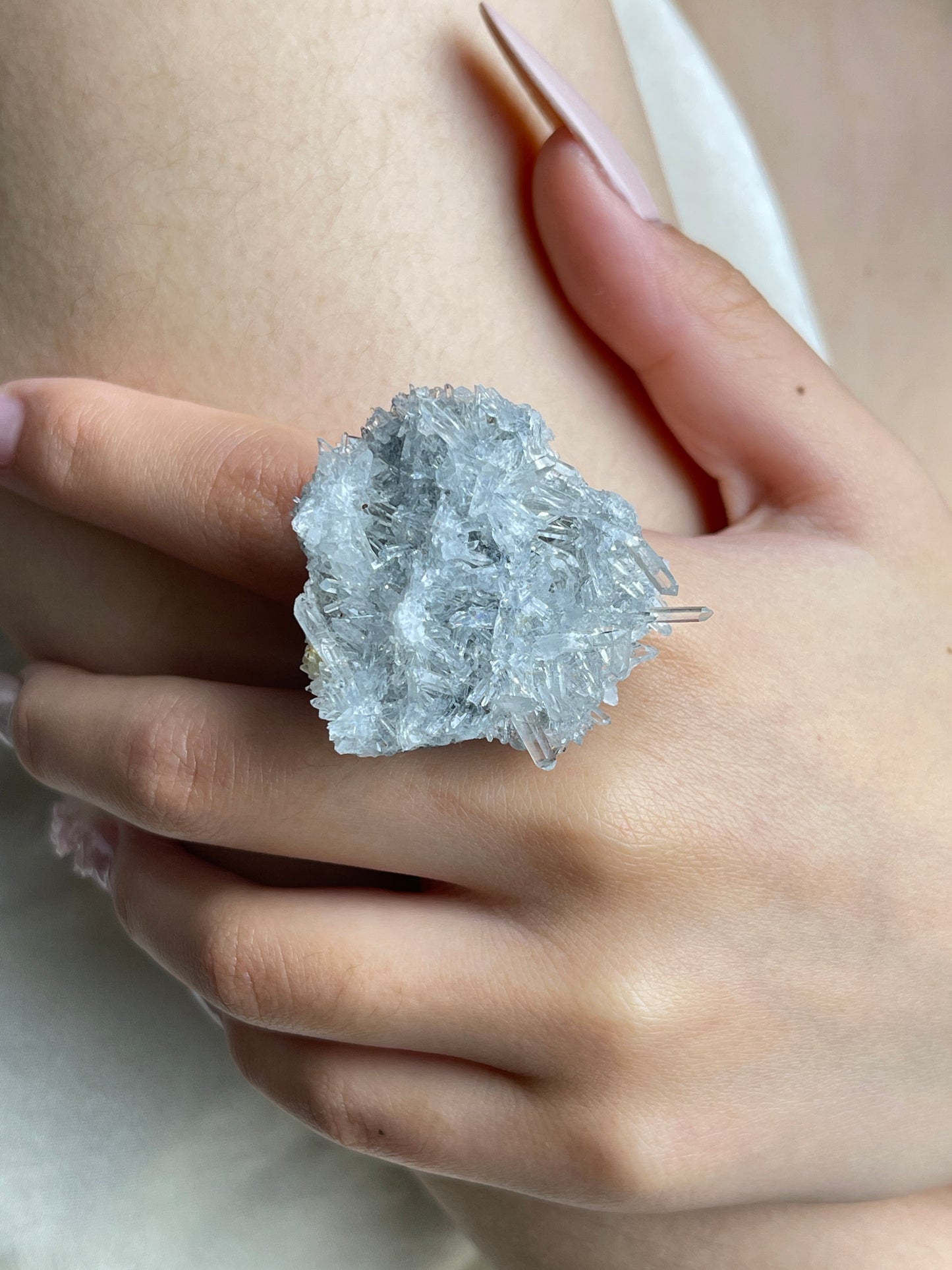 Close-up hand wearing Needle Quartz crystal cluster ring
