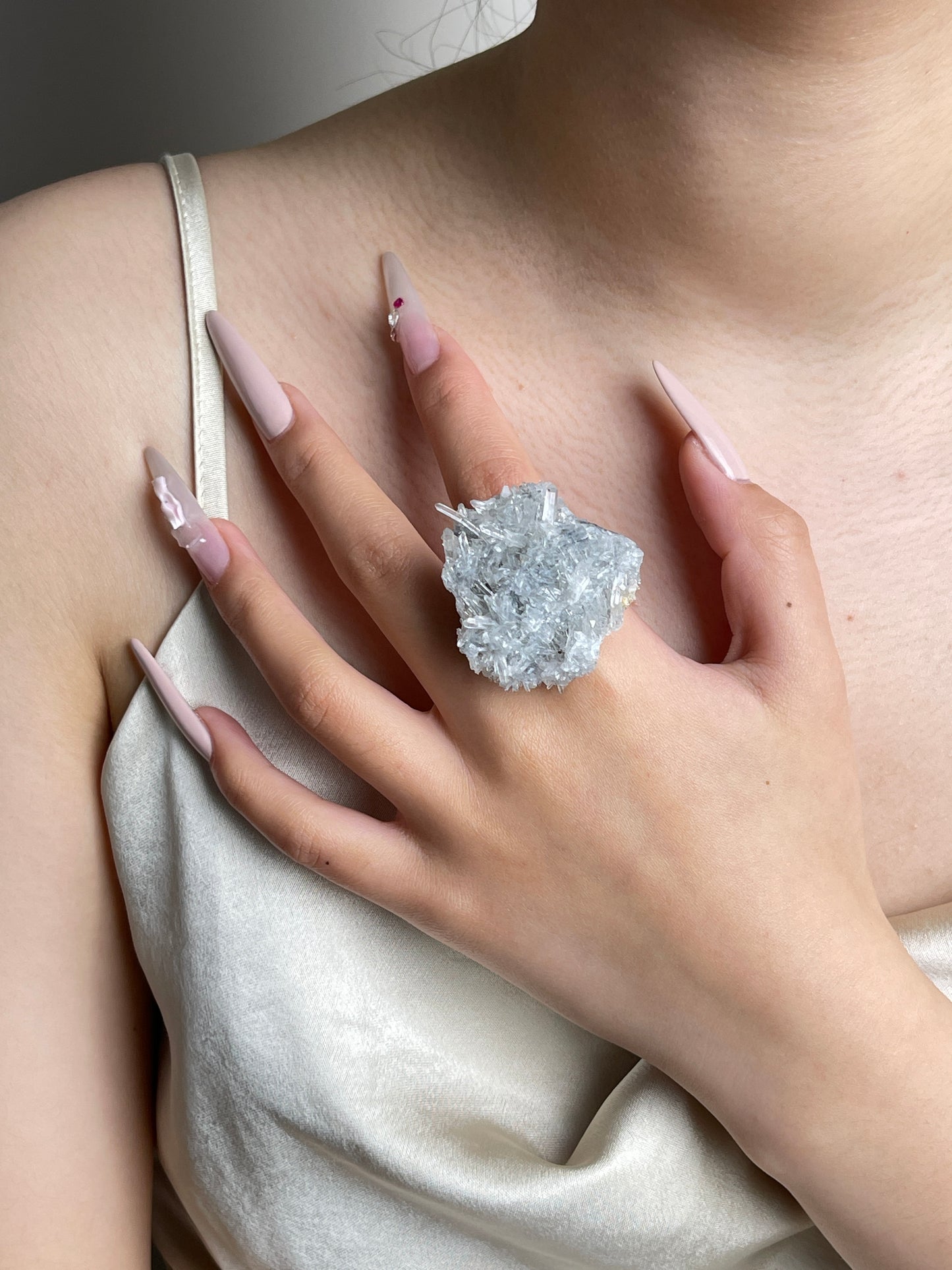 Needle Quartz crystal cluster ring worn on hand
