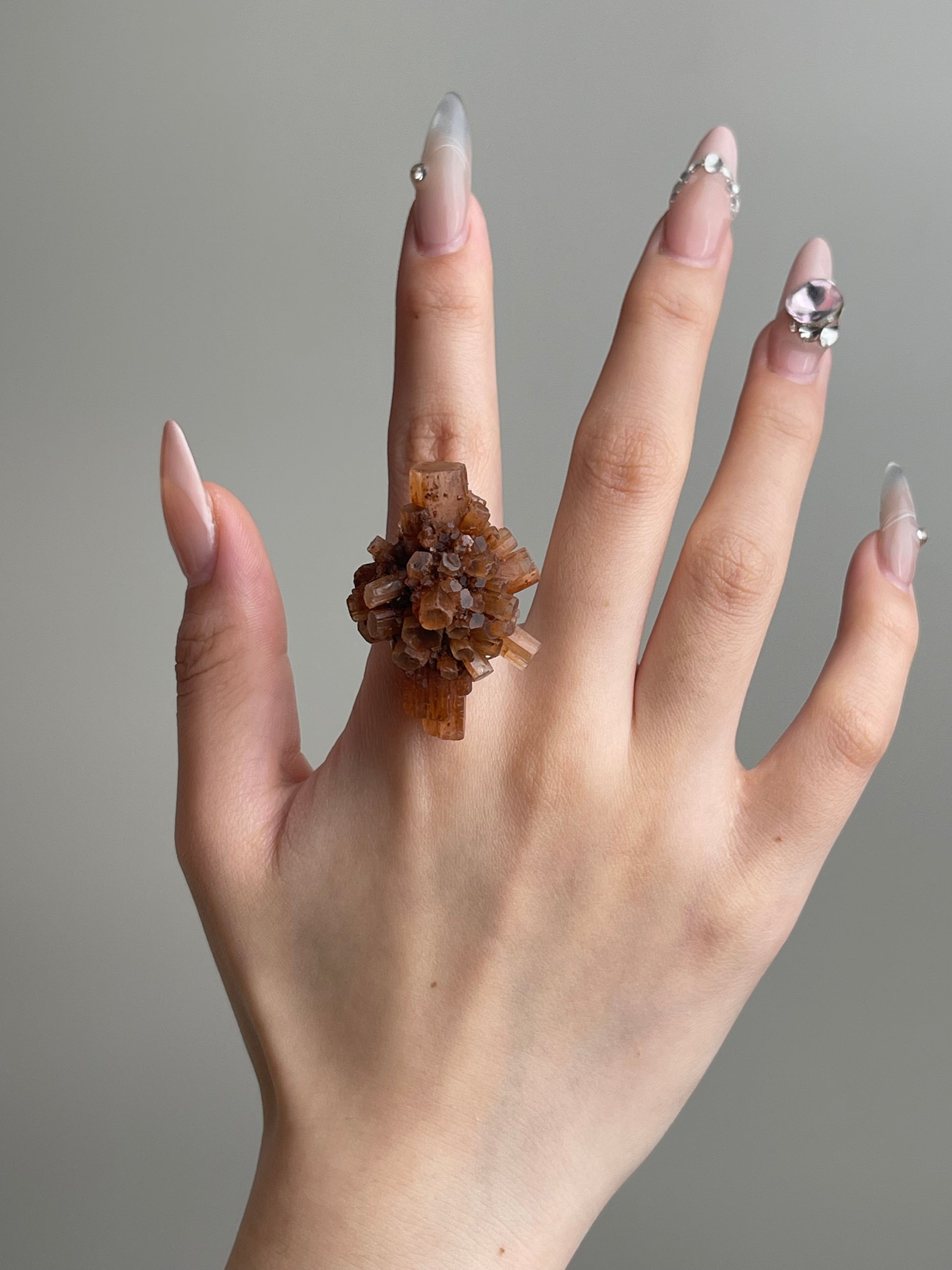 Moroccan Aragonite Mineral Specimen Ring worn on hand featuring raw radiating aragonite crystals