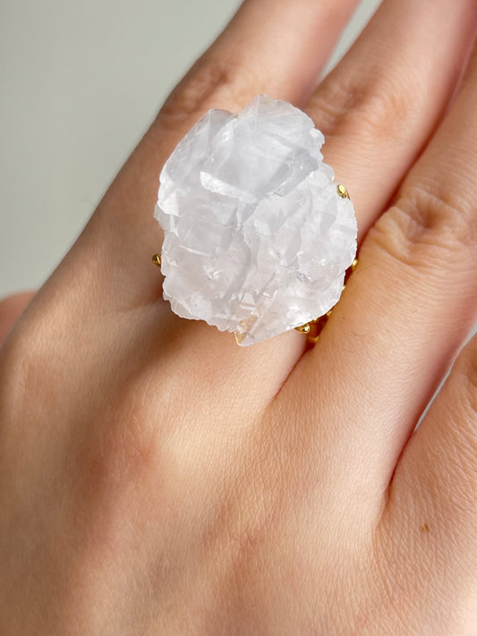 Close-up hand shot of White Pagoda Calcite Ring showing layered calcite crystal structure