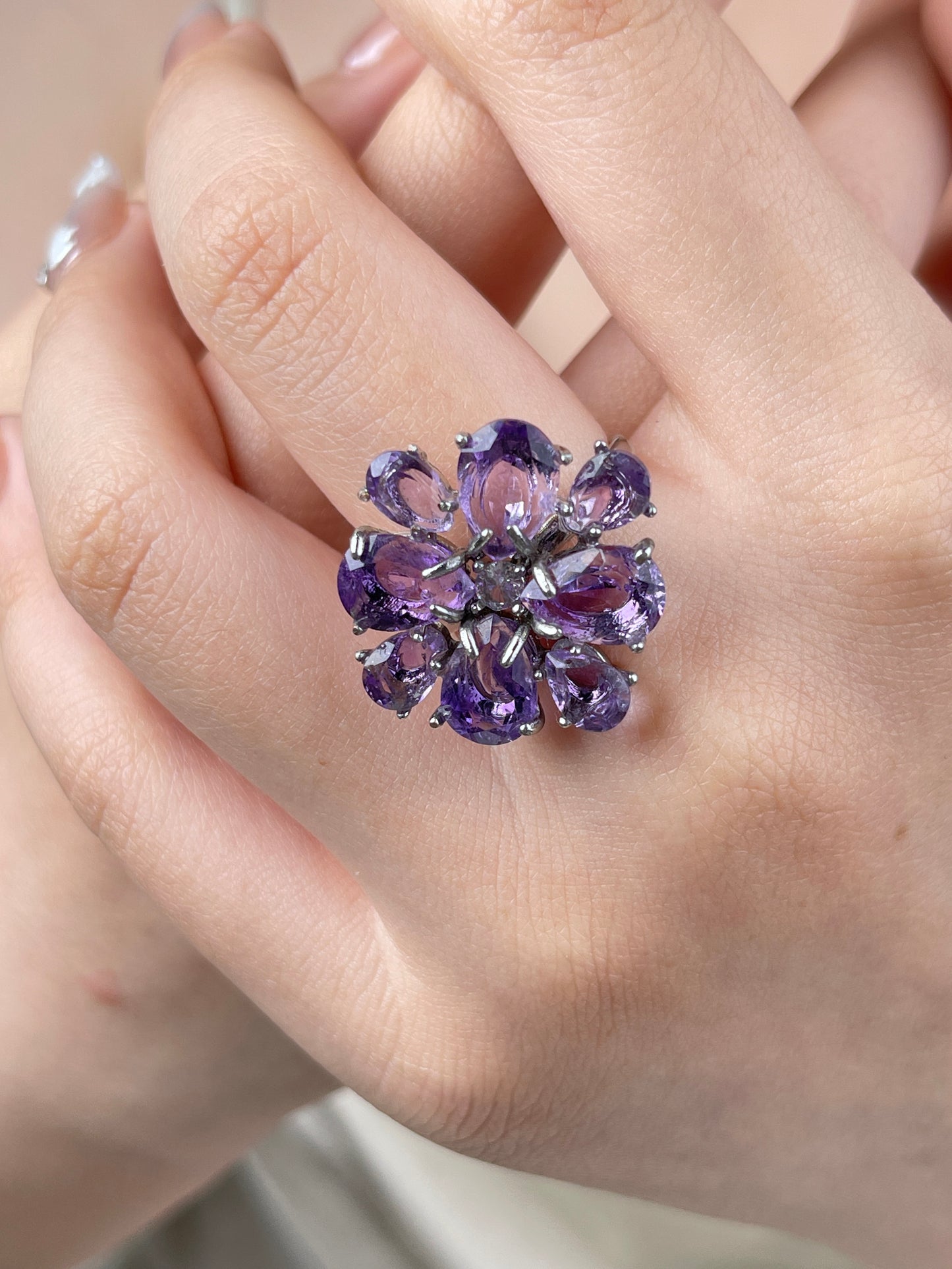 Pear-cut amethyst snowflake ring worn on hand, featuring luminous purple Brazilian amethyst in a delicate crystal design