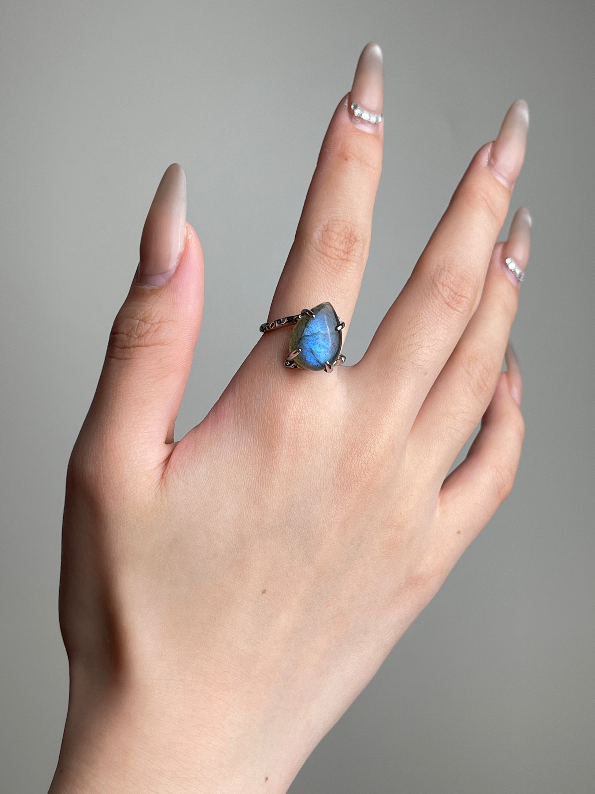 Pear cut Labradorite ring from India worn on hand with vivid natural blue flash