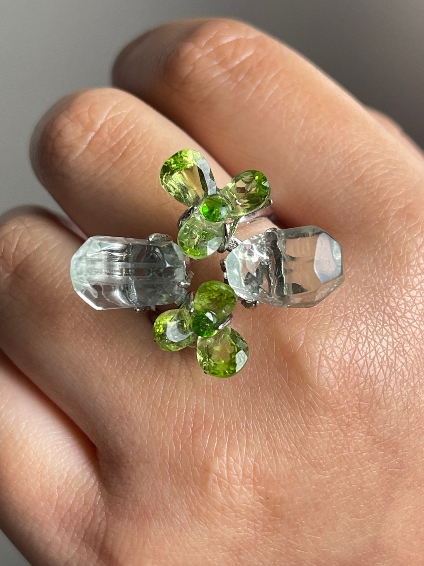 close up look peridot flower ring with green quartz