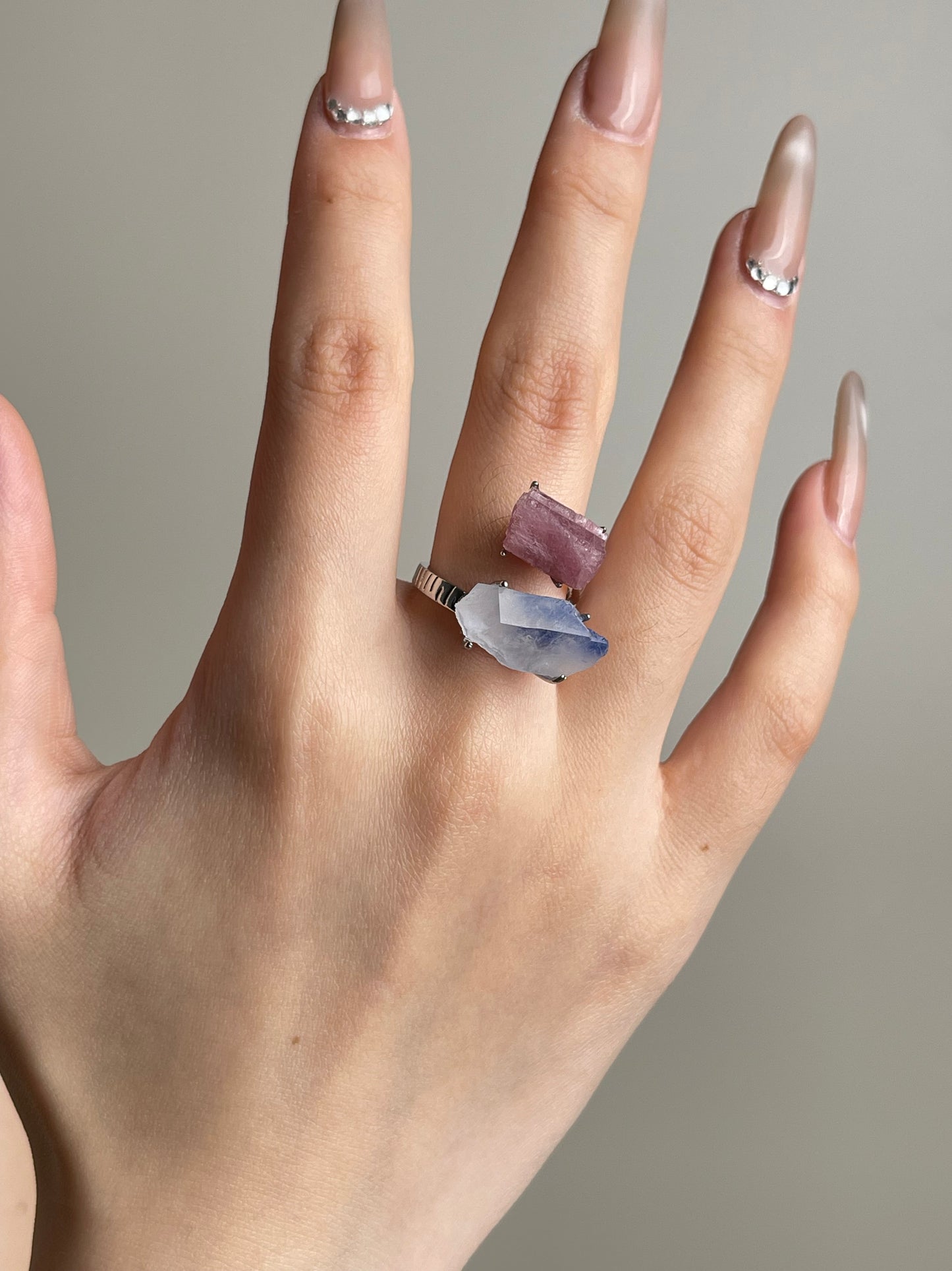 Hand wearing raw pink tourmaline and dumortierite quartz ring by Oryssia