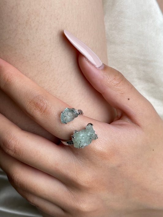 Close up of Green Prehnite and Aquamarine raw crystal ring on hand