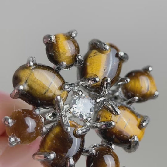 Video of tiger’s eye cabochon cluster ring showing golden chatoyancy