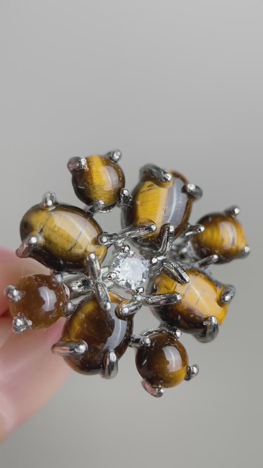 Video of tiger’s eye cabochon cluster ring showing golden chatoyancy