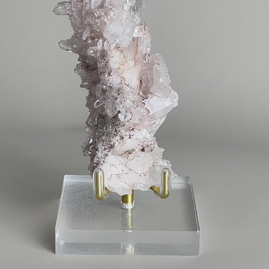 Alt text: Video of raw Pink Lemurian Quartz cluster with manganese oxides and soft pink crystal texture
