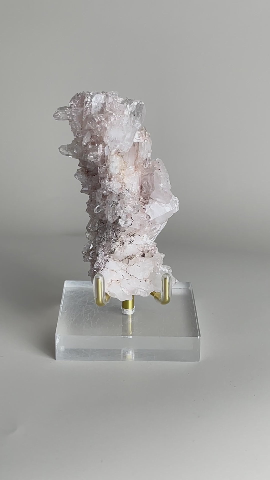Alt text: Video of raw Pink Lemurian Quartz cluster with manganese oxides and soft pink crystal texture