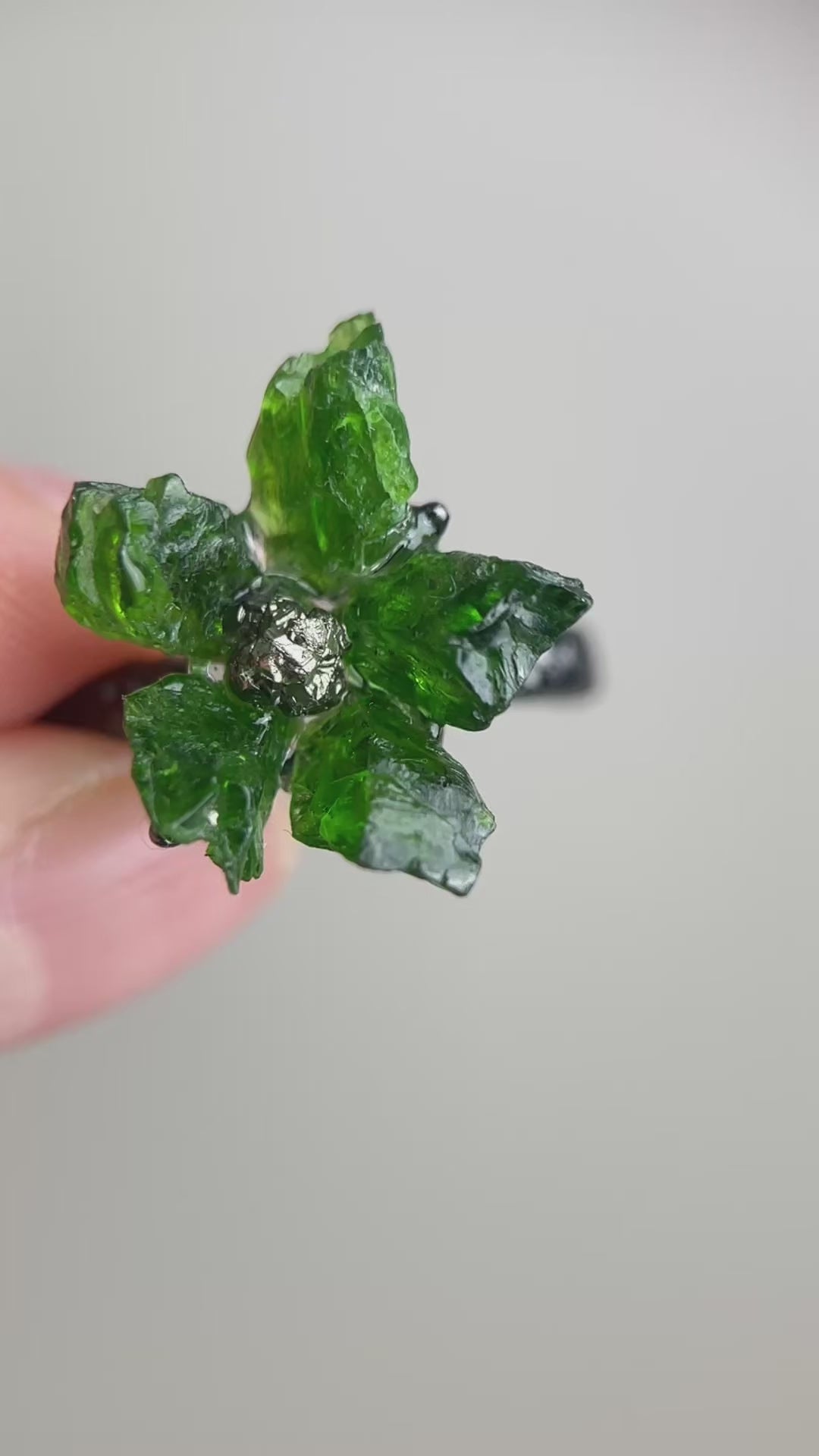 Video of Raw Chrome Diopside and Chalcopyrite flower ring showing deep green crystal flower detail