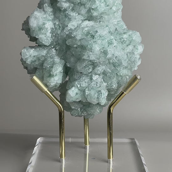 rotating green strawberry quartz cluster showing internal inclusions and crystal structure