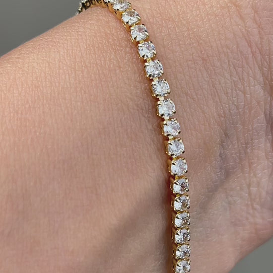 Video showing the sparkle and details of a gold-tone cubic zirconia tennis bracelet