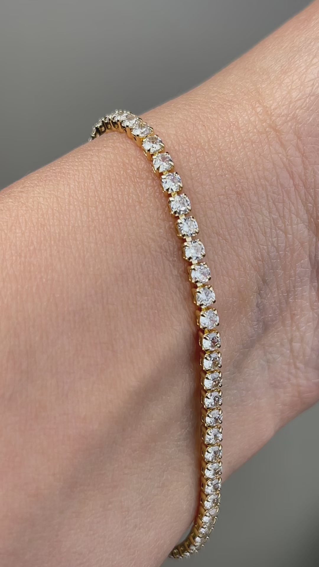 Video showing the sparkle and details of a gold-tone cubic zirconia tennis bracelet