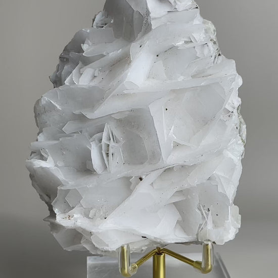 white rose calcite mineral specimen rotating display view showing layered crystal formation