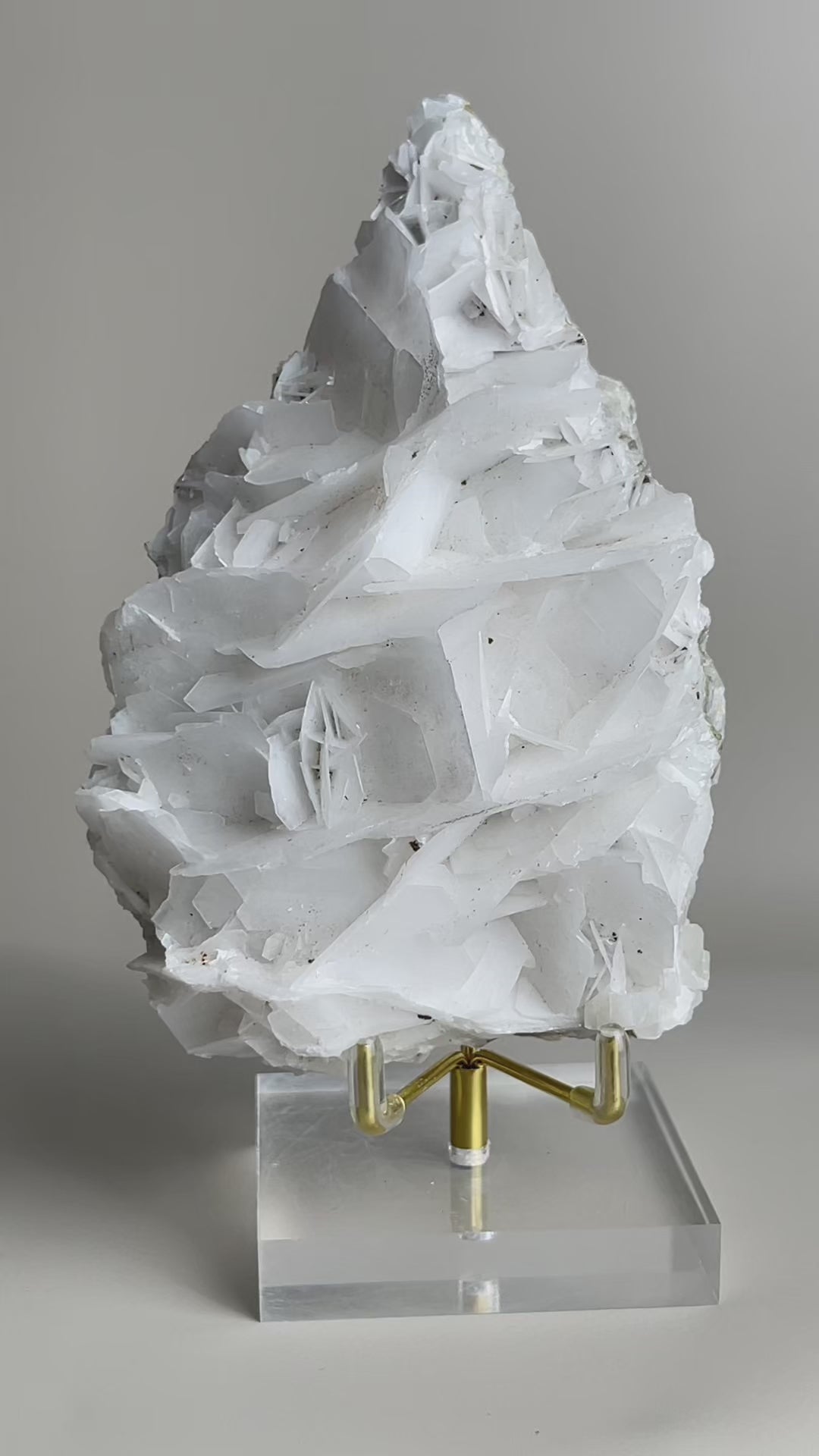 white rose calcite mineral specimen rotating display view showing layered crystal formation