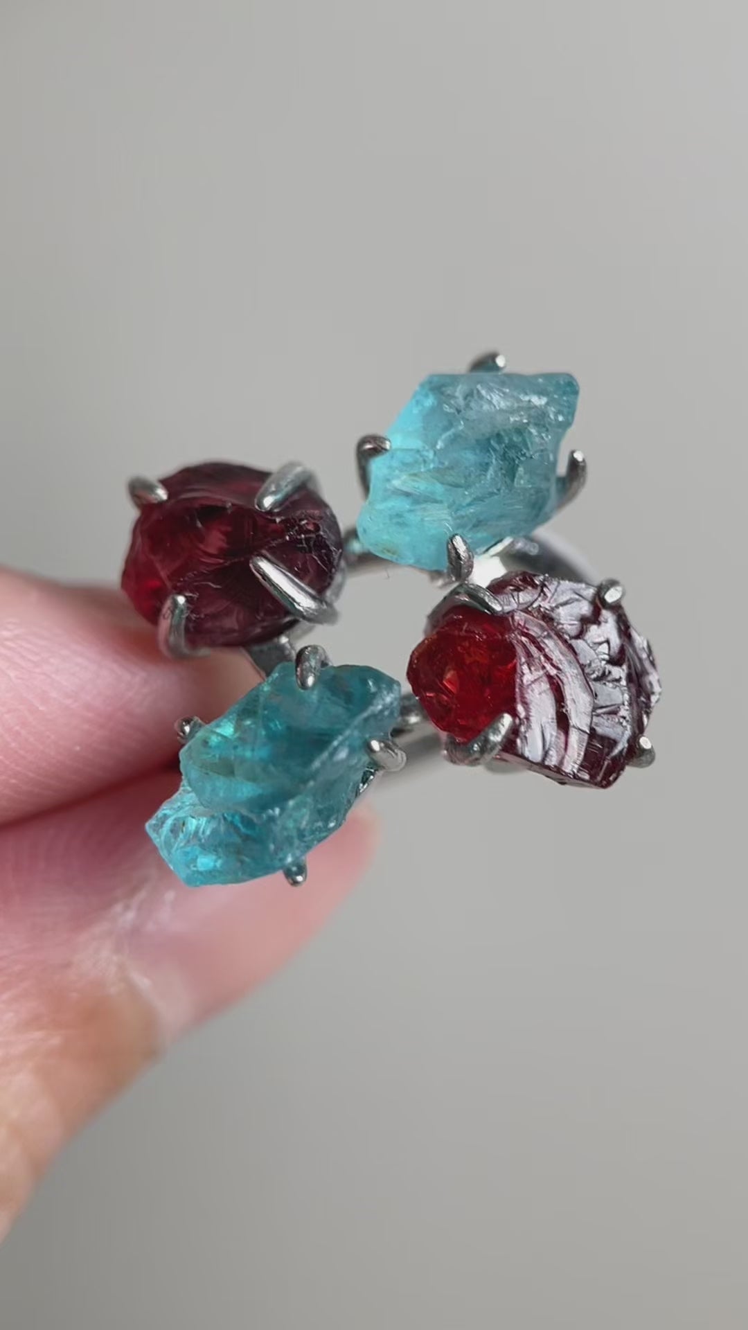 Video of Raw Garnet and Blue Apatite ring showing red and blue natural crystals