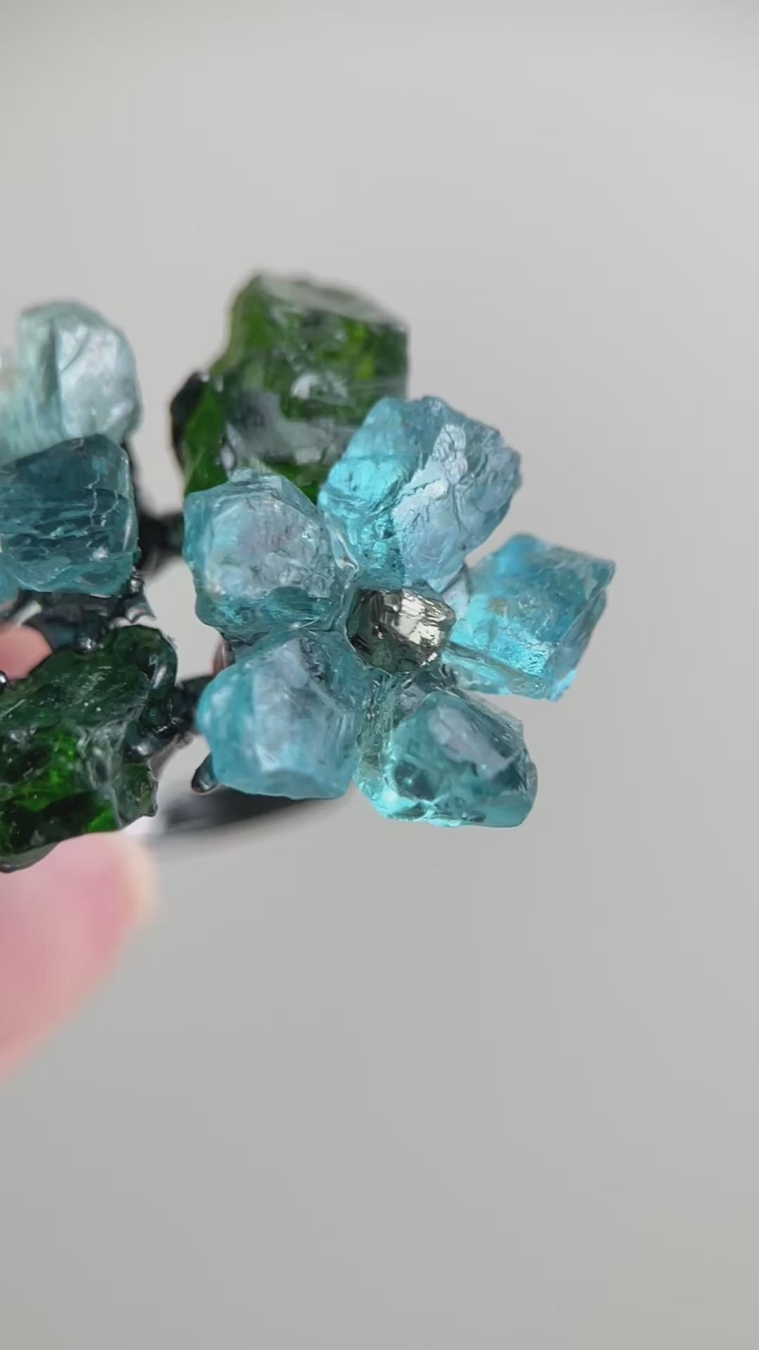 Video of Raw Blue Apatite flower ring with Chalcopyrite center and Chrome Diopside stones