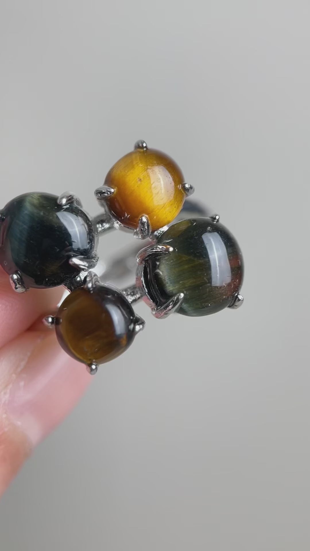 Video of tiger’s eye and blue tiger’s eye ring showing moving chatoyancy and polished quartz stones