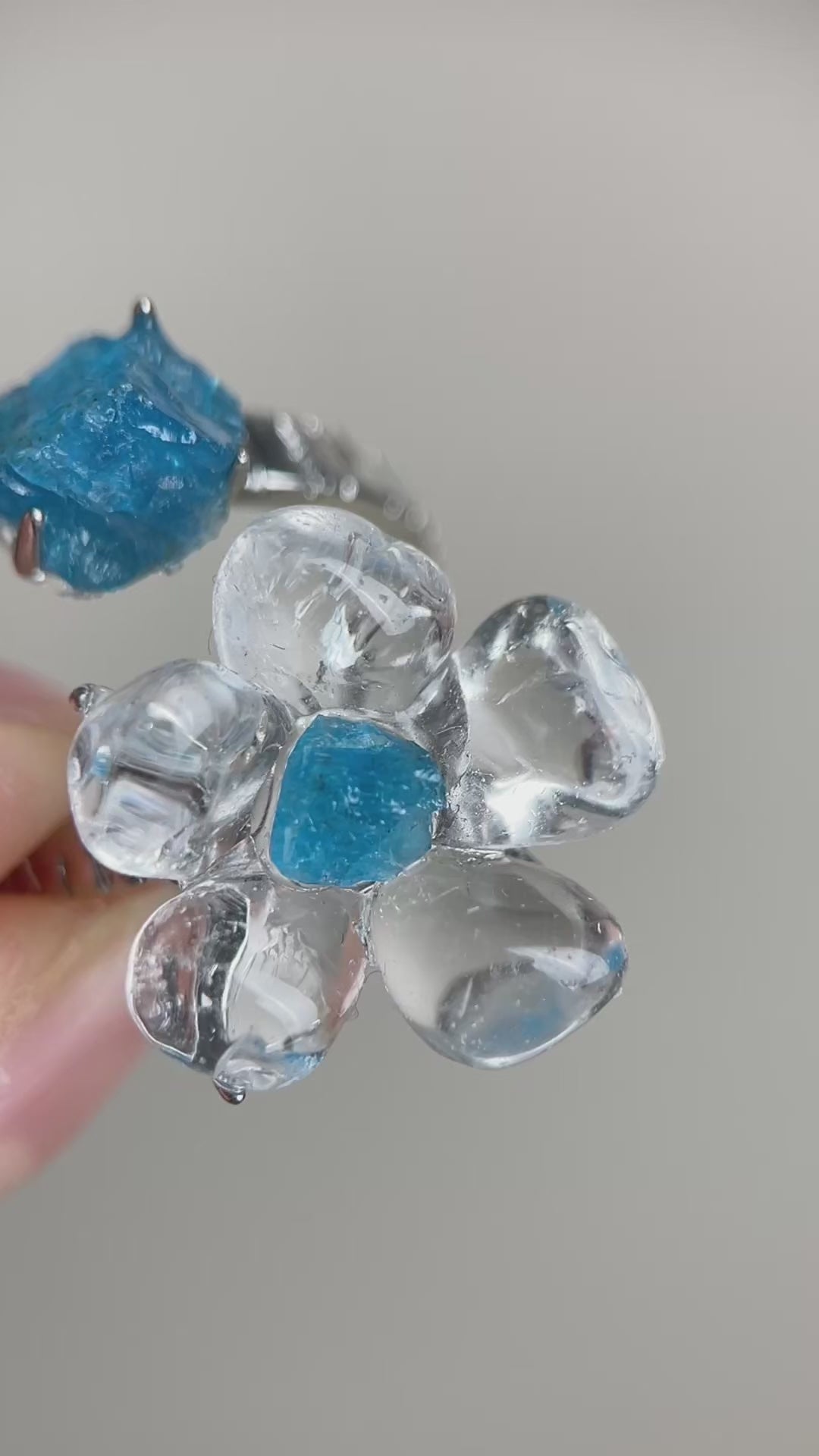 Video of Clear Quartz Flower Ring with polished quartz petals and raw Blue Apatite accents