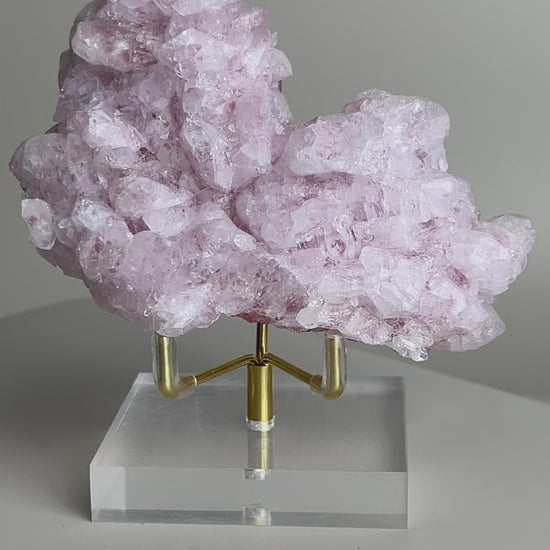 rotating pink strawberry quartz cluster showing internal inclusions and crystal structure