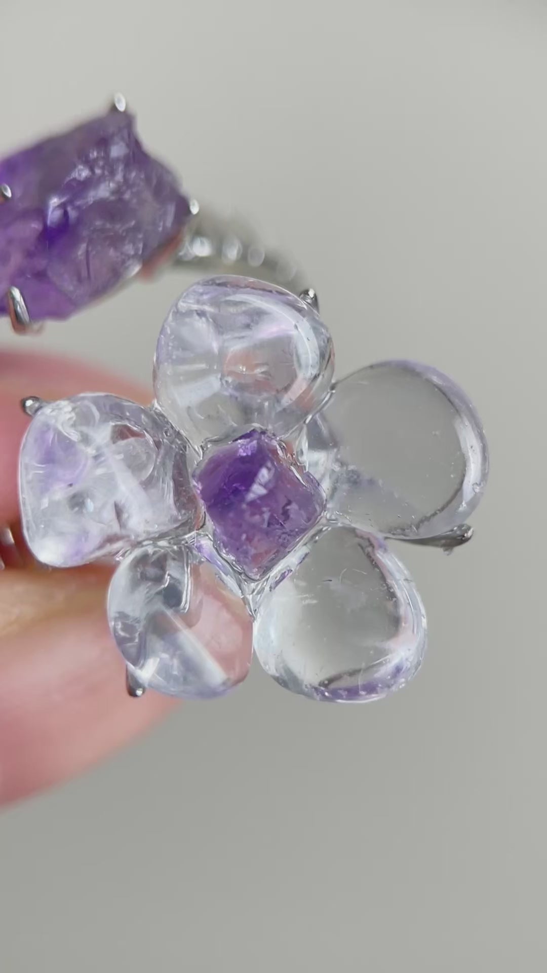 Video of Clear Quartz Flower Ring with polished quartz petals and raw Amethyst accents