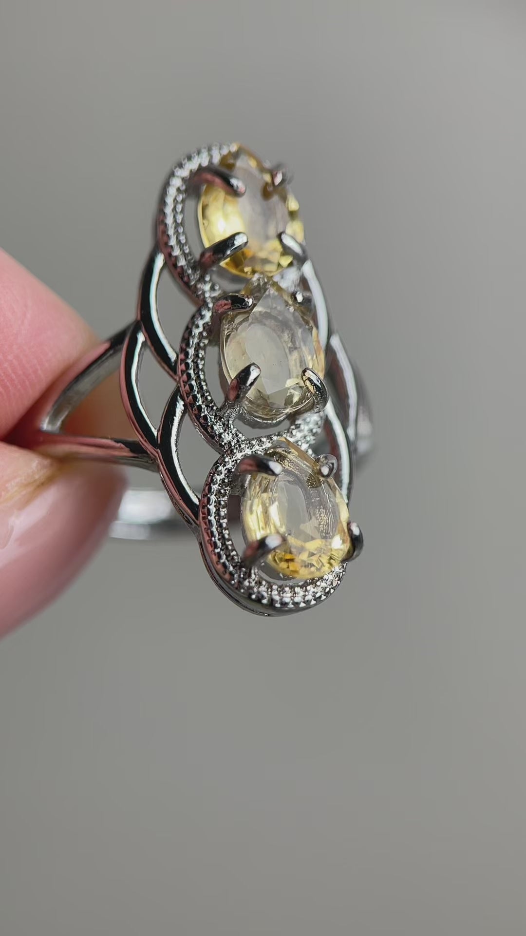 citrine pear cut ring video showing three stone design and light reflection