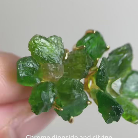 Raw Chrome Diopside flower ring with deep green crystal petals and a natural citrine center, handcrafted mineral specimen jewelry with organic textures and vibrant contrast