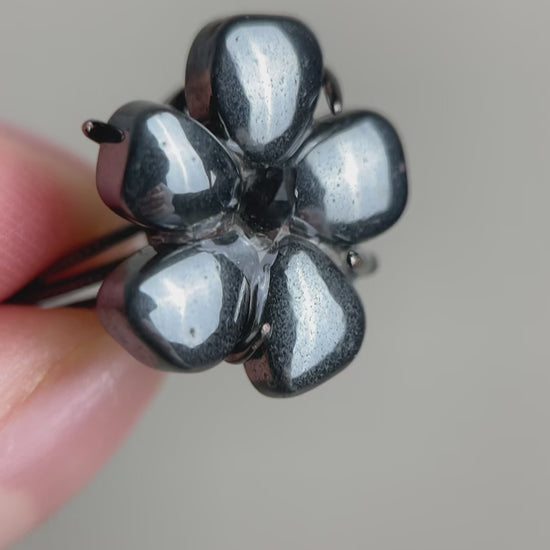 Hematite flower ring with Herkimer  Diamond Quartz (Pakistan), showing natural metallic texture and clear crystal points in raw crystal form