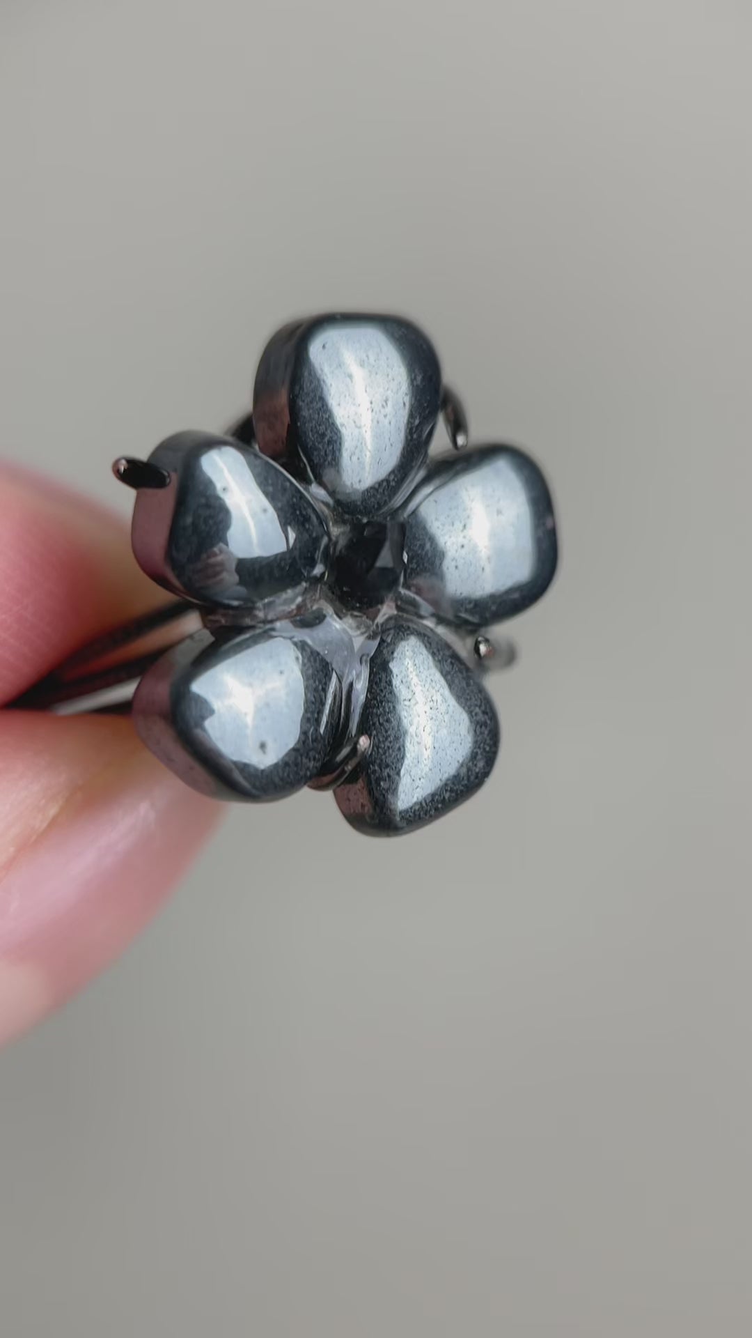 Hematite flower ring with Herkimer  Diamond Quartz (Pakistan), showing natural metallic texture and clear crystal points in raw crystal form