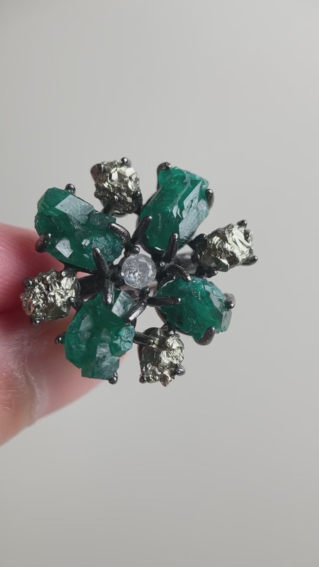 Video of raw Dioptase and Chalcopyrite snowflake ring showing vivid green and metallic gold minerals