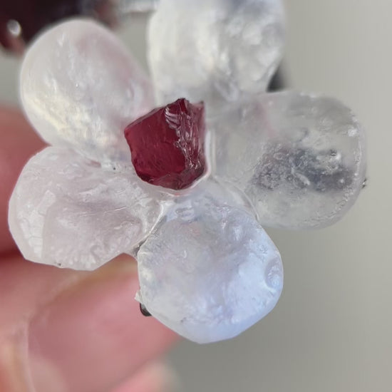 Video of Moonstone and Garnet crystal flower ring showing soft glow and red stone detail