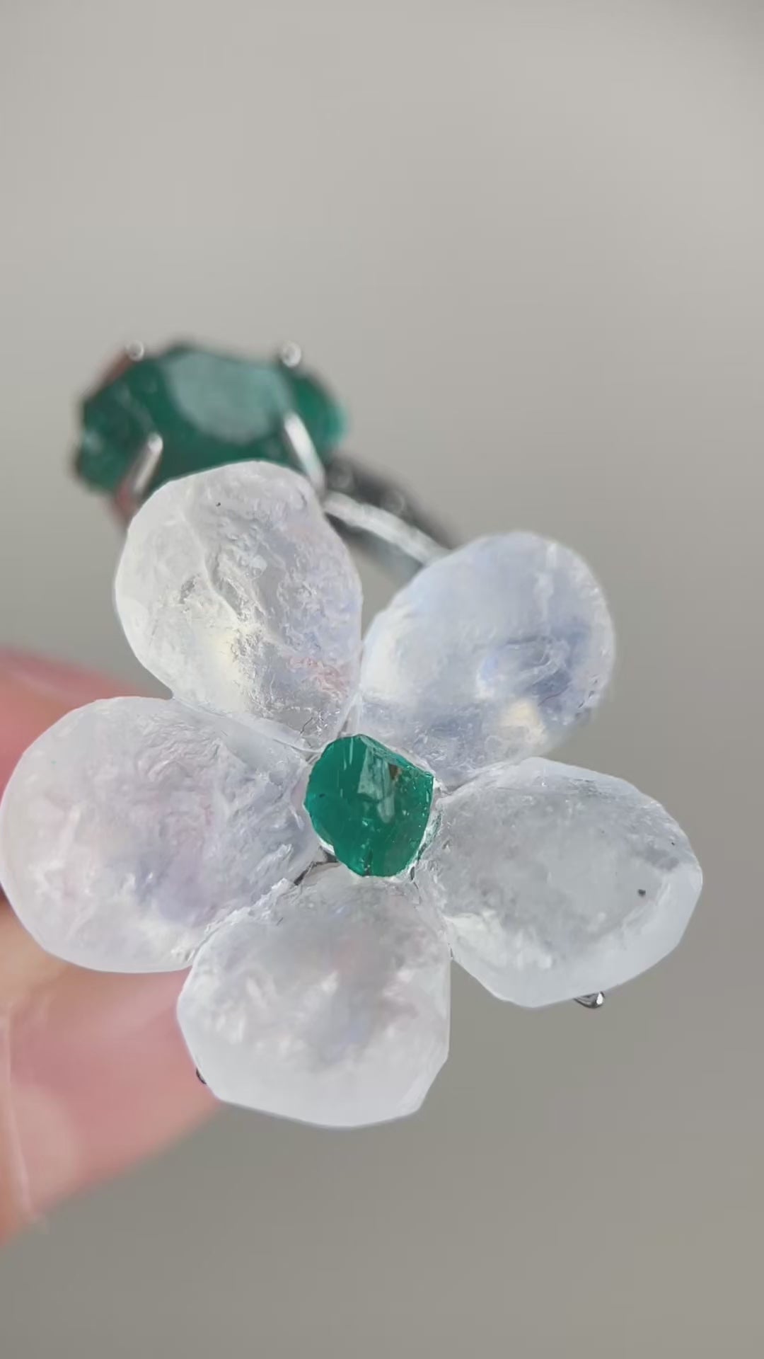 Video of Moonstone and Dioptase crystal flower ring showing soft glow and flower detail
