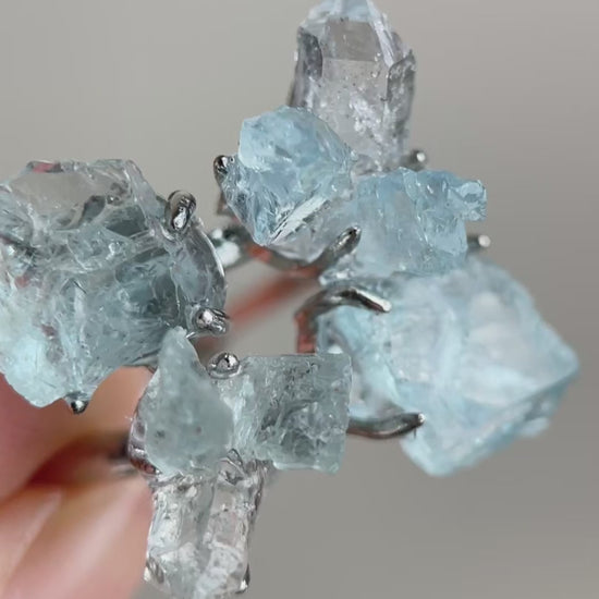 Video of raw Aquamarine and Herkimer Diamond Quartz flower ring showing blue and clear crystals