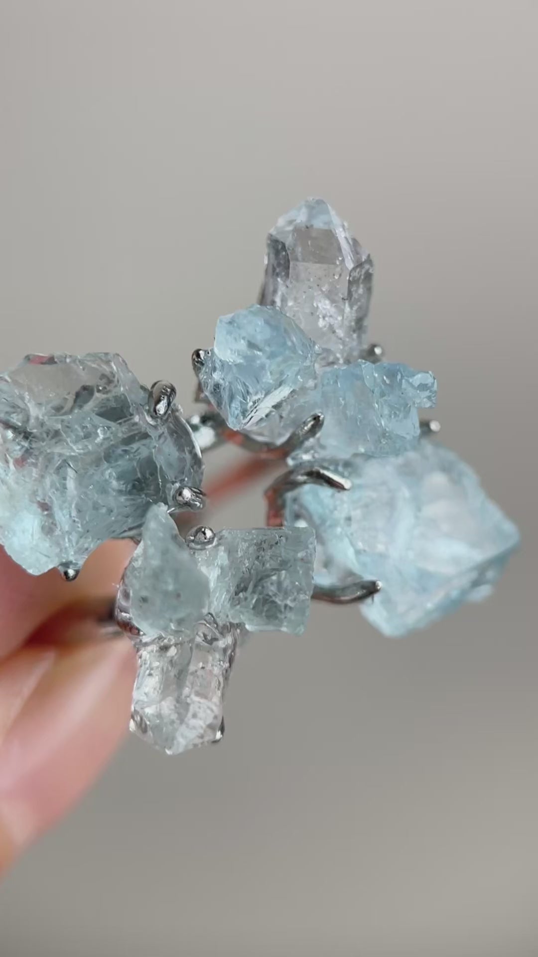 Video of raw Aquamarine and Herkimer Diamond Quartz flower ring showing blue and clear crystals