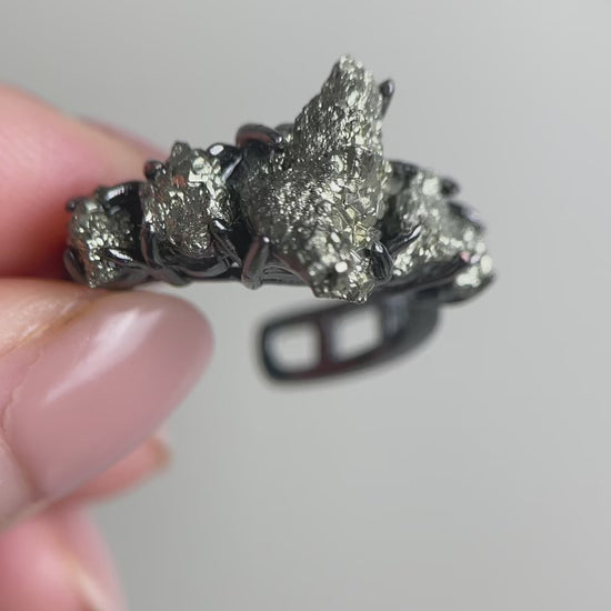 Video of Chalcopyrite row ring showing natural metallic iridescent crystal surface and band design