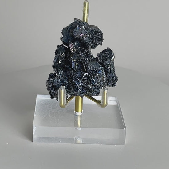 Video of Rainbow Carborundum cluster mineral specimen showing iridescent metallic crystal reflections from different angles.