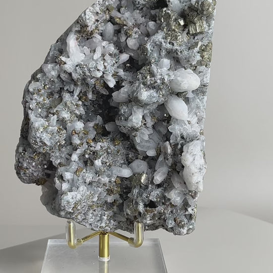 rotating view of quartz with chalcopyrite mineral specimen showing crystal texture and metallic luster