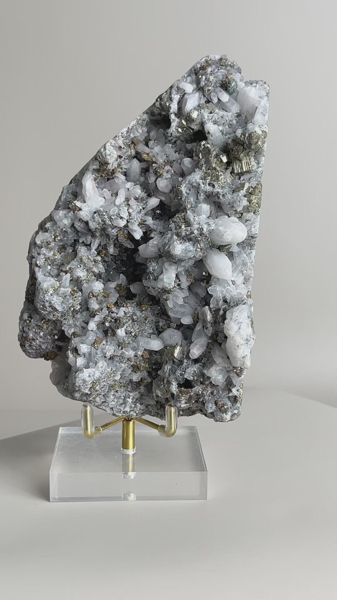 rotating view of quartz with chalcopyrite mineral specimen showing crystal texture and metallic luster