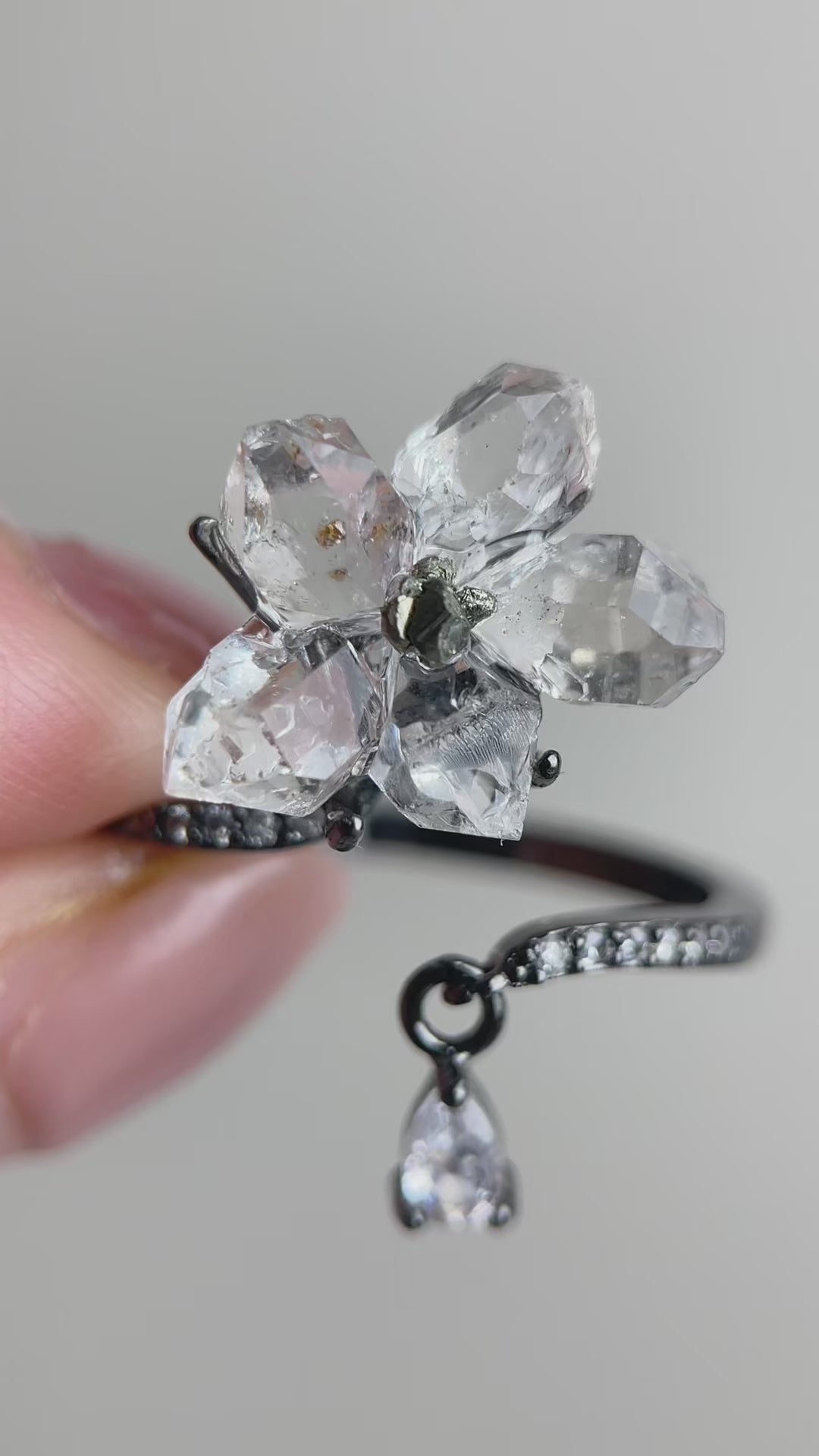Hakima Diamond Quartz flower ring with clear double-terminated quartz crystals and a Peruvian chalcopyrite center, handcrafted mineral specimen jewelry with natural sparkle and raw texture