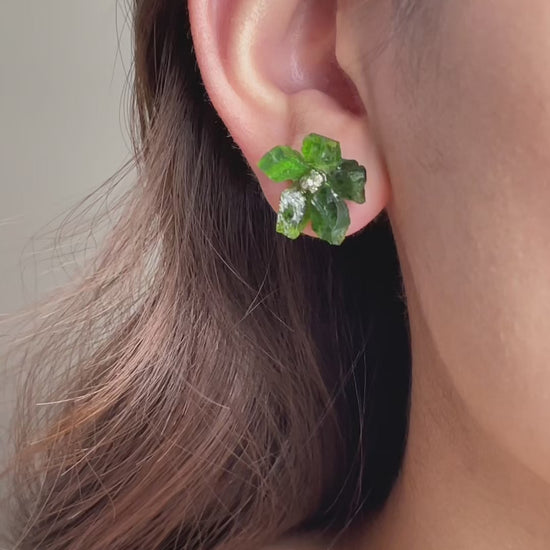 Video of Chrome Diopside and Chalcopyrite flower stud earrings in sterling silver showing deep green crystal petals and metallic centre detail
