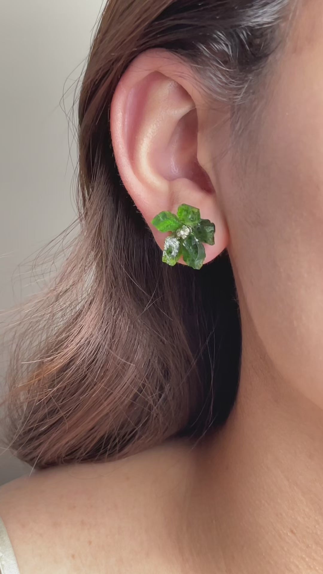 Video of Chrome Diopside and Chalcopyrite flower stud earrings in sterling silver showing deep green crystal petals and metallic centre detail