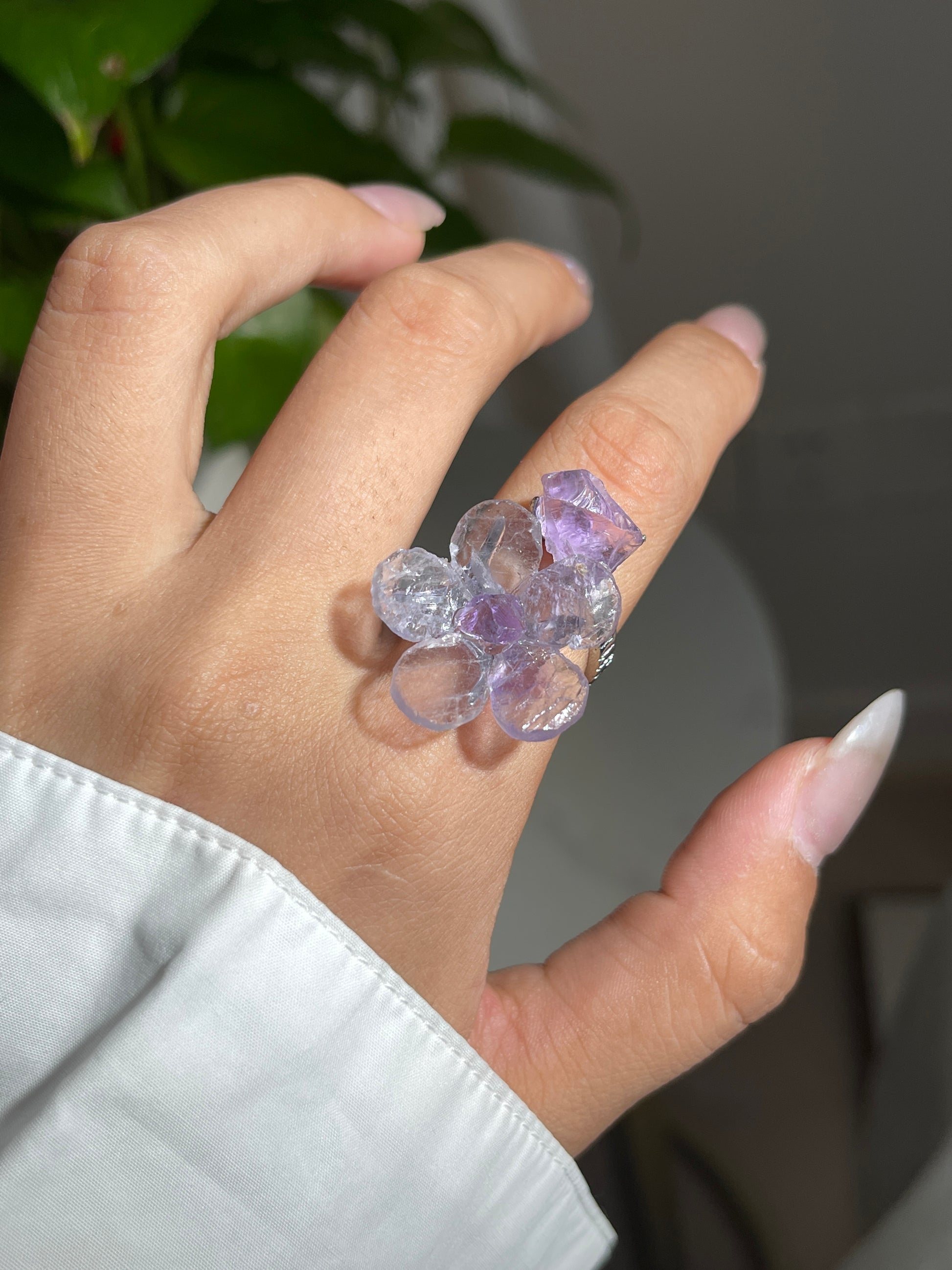 Close-up of Purple Fluorite and Amethyst crystal flower ring worn on hand