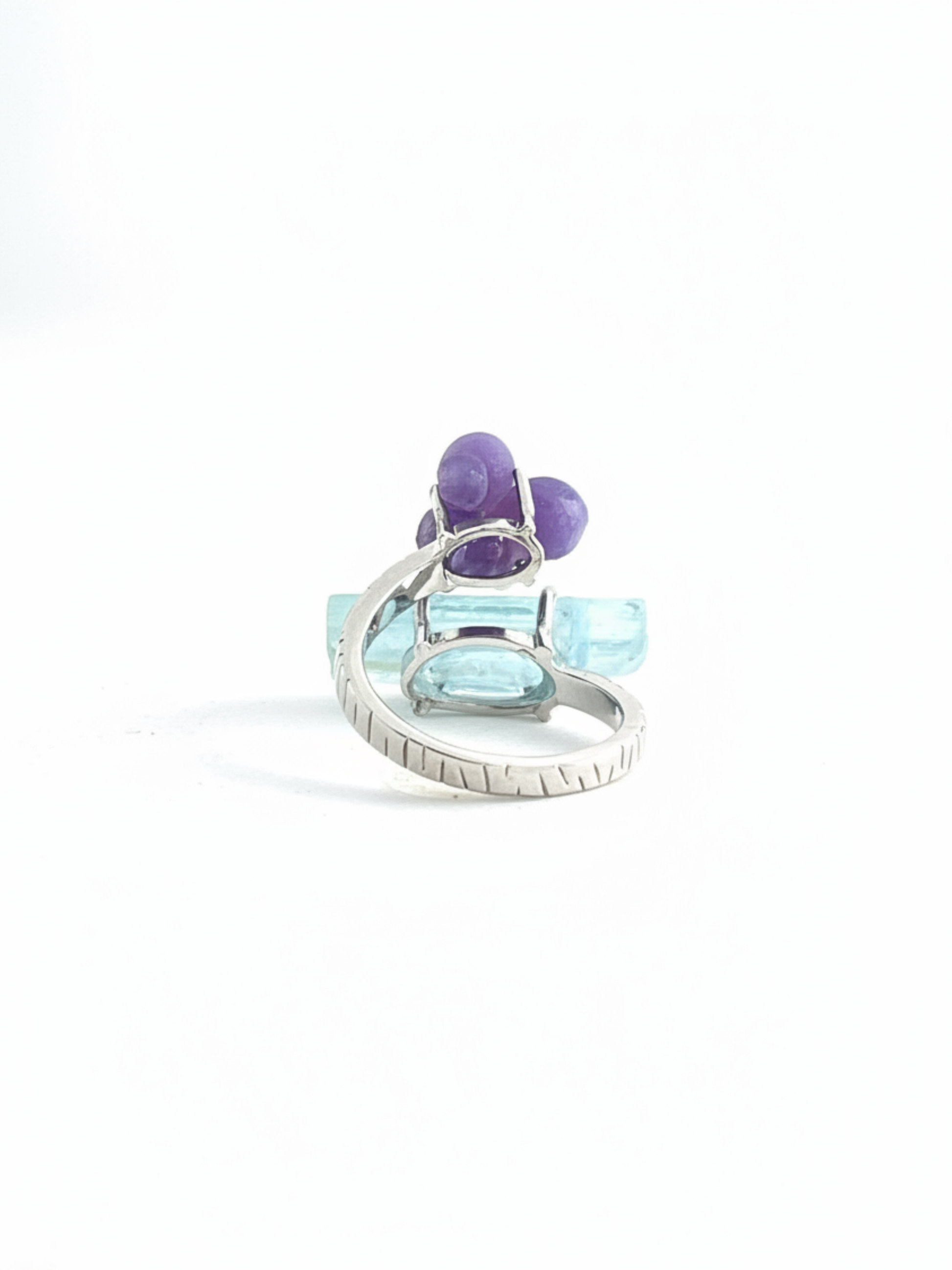 Back view of purple grape agate and aquamarine ring showing adjustable open band and crystal setting