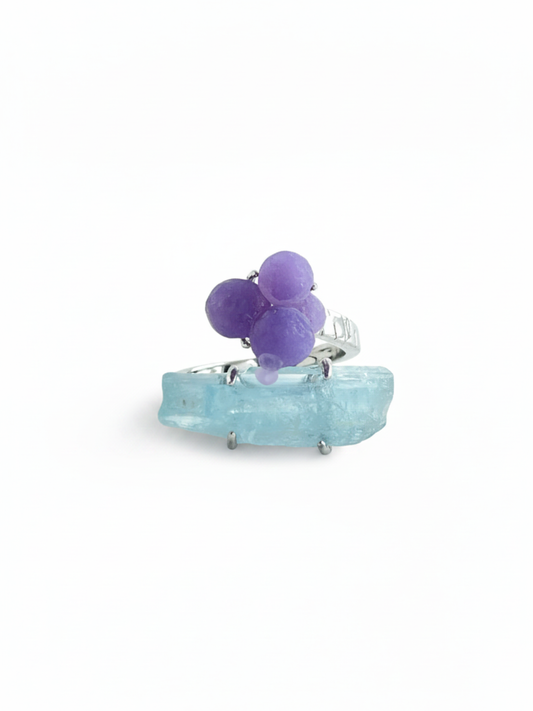 Purple grape agate and aquamarine ring front view with rounded purple agate cluster and blue aquamarine crystal