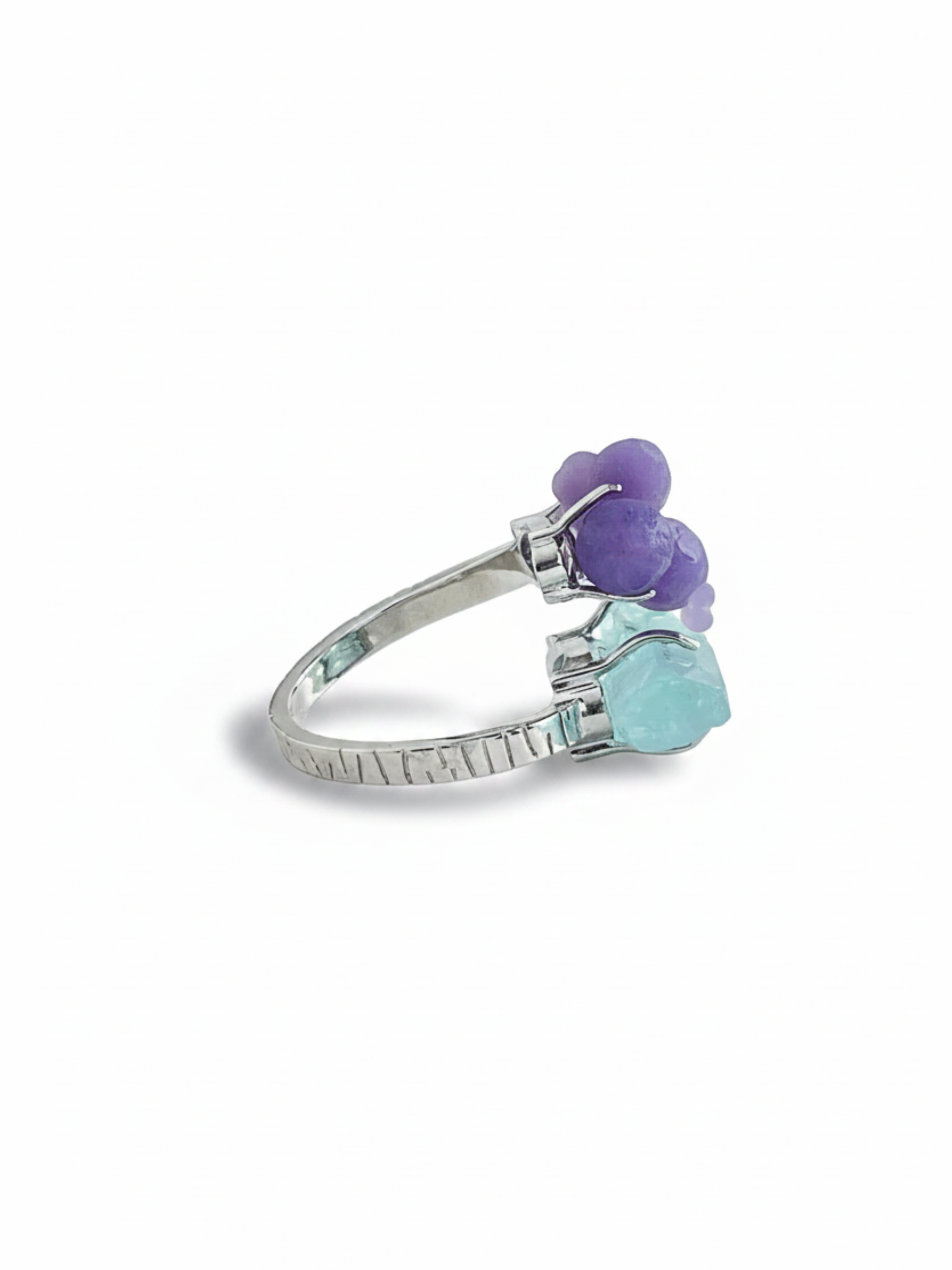 Side view of purple grape agate and aquamarine ring with raw crystal setting and silver tone band
